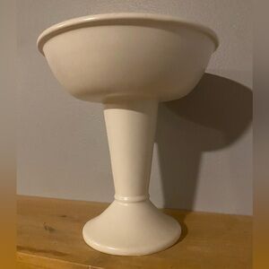 A Mid-Century Modern Haeger Pottery cream-colored pedestal planter.